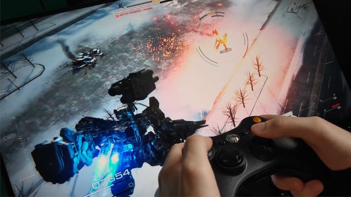 Игрок Держит Контроллер Xbox Рядом С Экраном Монитора, Играя В Armored Core 6.