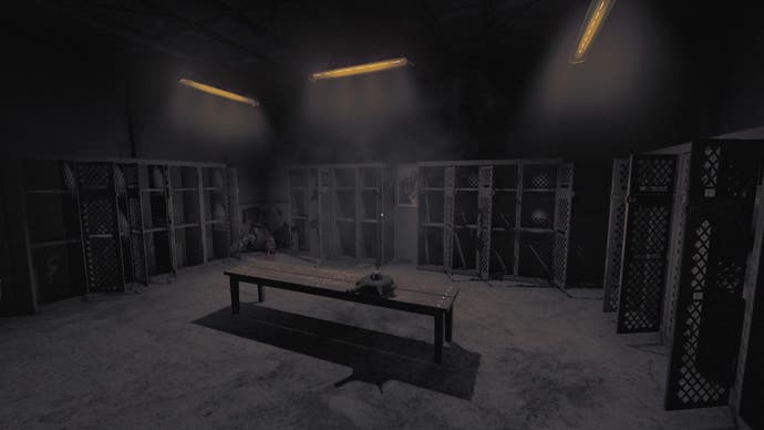 Amnesia: The Bunker review screenshot shows a locker room with most of the lockers wide open. A body was dumped in the corner of the room, but in the dim light, only the chest down was visible.