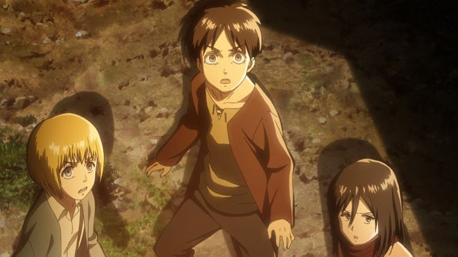 Image taken from Attack on Titan showing main characters Eren, Armin and Mikasa.