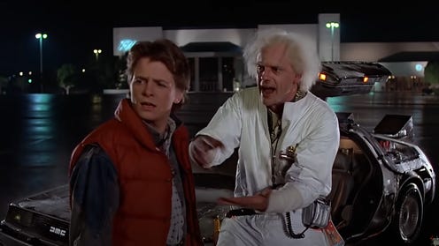 Michael J Fox and Christopher Lloyd next to the Delorean in Back to the Future