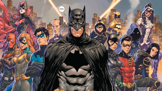 Batman says cheese for the posing Bat-family