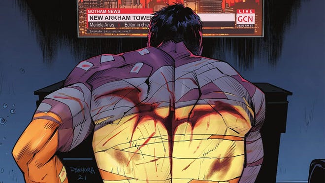 Comic image of Batman watching the news, showcasing his bandaged back and the Batman symbol