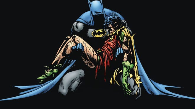 Batman cradles Robin's corpse
