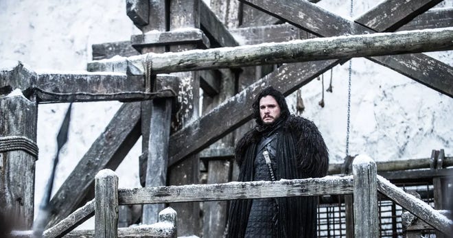 Still promotional image of Jon Snow standing at the wall
