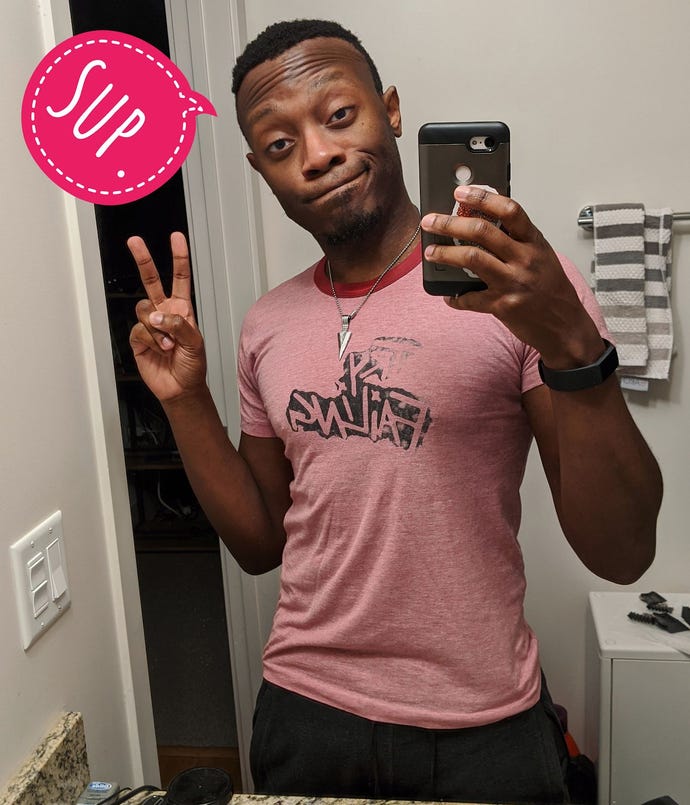 A mirror selfie of the developer Benji Bright, throwing up the peace sign and with an overlaid bright pink speech bubble saying 'Sup.'