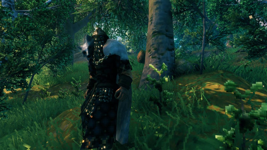 A Valheim screenshot of the player wearing full Padded Armor, standing in front of a forest.