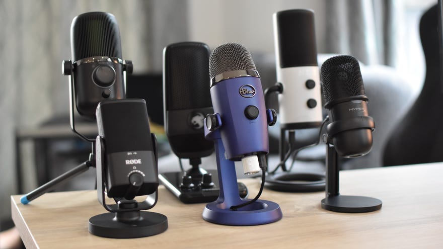 A collection of some of the best microphones for gaming, arranged on a desk.