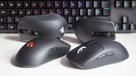 A photo of four wireless gaming mice in front of a keyboard