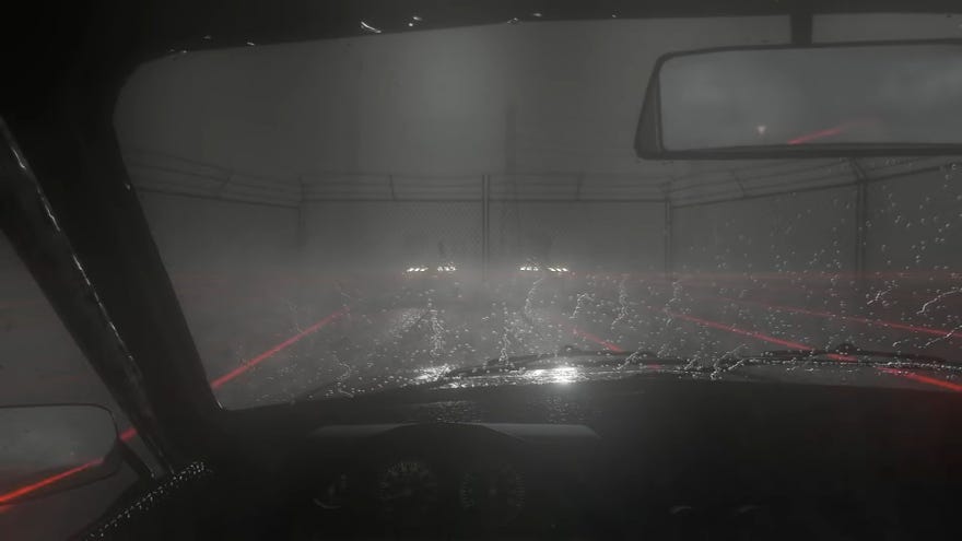 A dark, rainy scene looking out of a car windscreen, in which two pairs of headlights can be seen in the distance in Beware