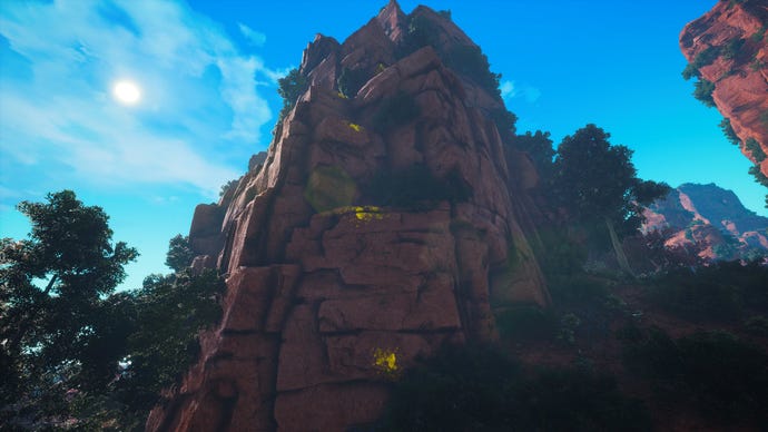 A Biomutant screenshot of a mountain with yellow paint on the side, indicating points you can use to quickly scale the mountain.