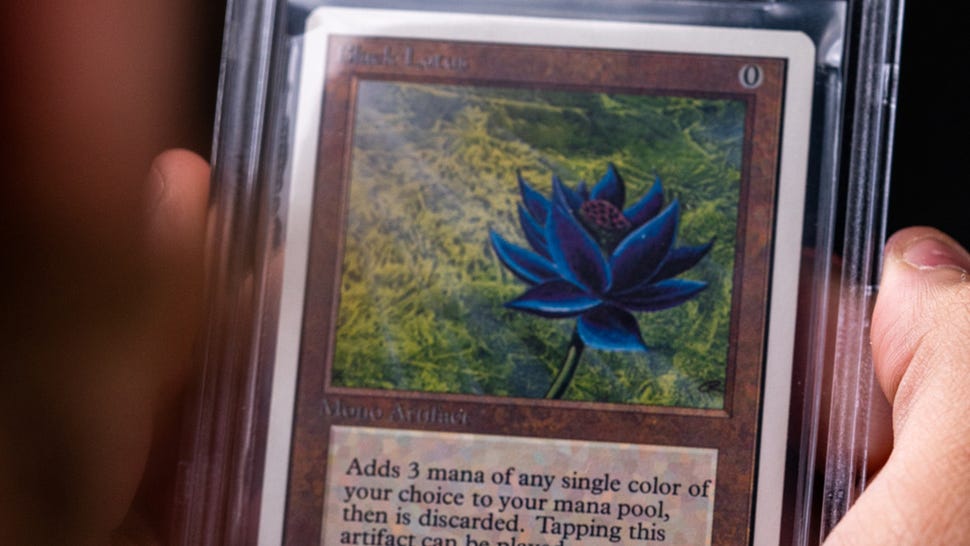 A hand holding a Magic: The Gathering Black Lotus card
