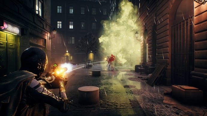 A character in Bloodhunt shoots at an enemy player with a silenced SMG in the streets of Prague.