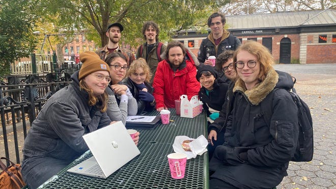 Photograph of Brooklyn Strategist Workers Union members on a park bench.