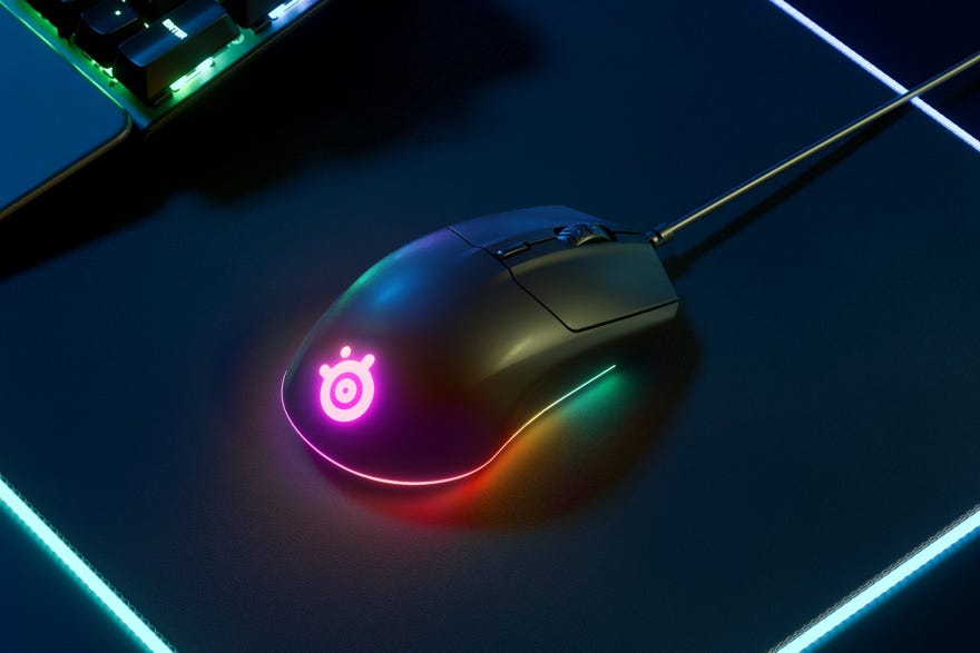 a photo of the steelseries rival 3 mouse, with RGB lighting aglow on a dark background