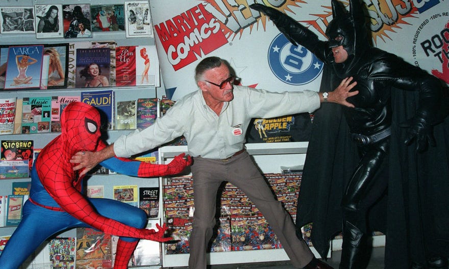 Stan Lee with a Spider-Man and Batman cosplayer