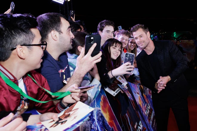 Chris Hemsworth taking photographs with fans