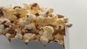 Close up photograph of popcorn in a white cardboard box