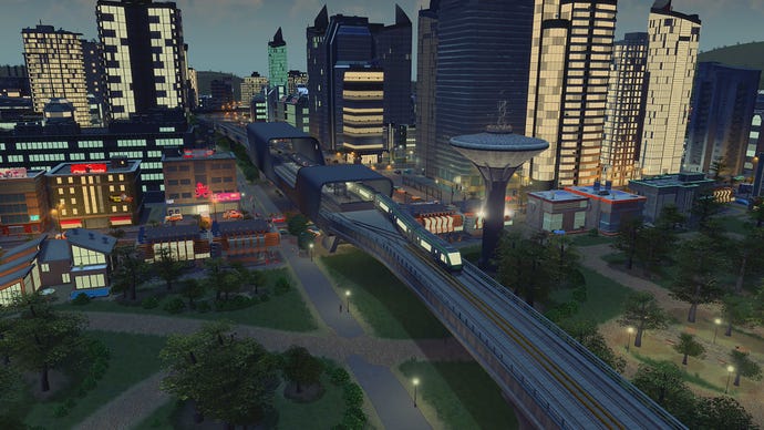 A screenshot of Cities Skylines showing a new train station at night added as part of the Train Stations content creator pack.