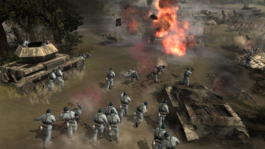 Soldiers storm a muddy battleground in Company Of Heroes