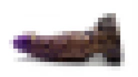 A blurred picture of a fairly enormous purple and gold dildo, an official piece of merch for The Cosmic Wheel Sisterhood
