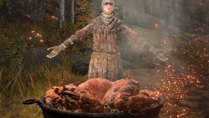 A character in some chainmail armour stands open armed behind a gigantic, steaming, pot of crab.