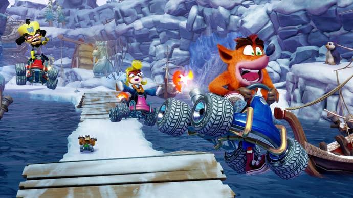 In Crash Team Racing Nitro Fueled Remaster, Crash, Coco and Cortex all jump into the foreground on an icy track.