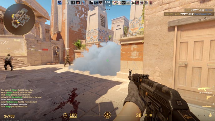The player points an AK at a smoke on Anubis in CS2.