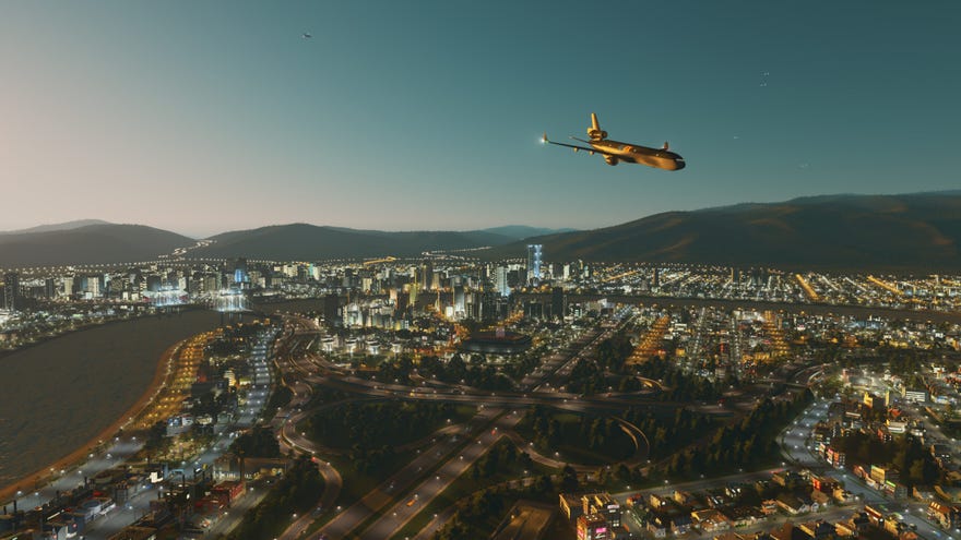 A screenshot of Cities: Skylines Airports DLC< showing a jet flying low over a glittering city at night.