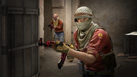 A terrorist in CS:GO with a special skin for the AK-47 heads through a doorway, followed by a teammate.