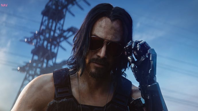 Johnny Silverhand takes off his sunglasses and looks down at the camera in a Cyberpunk 2077 cinematic trailer.