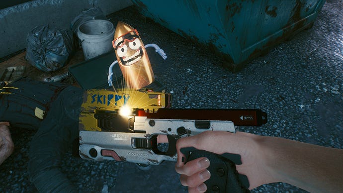 The player looks down at the ground in Cyberpunk 2077 and holds out Skippy, a unique talking pistol. The pistol is projecting a hologram of a cartoon-style anthropomorphised bullet wearing goggles.