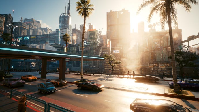 A screenshot of a busy street of Night City in Cyberpunk 2077 during the day, with the city skyline in the background.