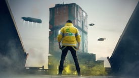 Male V from Cyberpunk 2077 stands before a Corpo building in Night City with their back to their camera, wearing a yellow jacket.