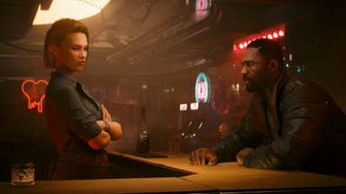 Cyberpunk Phantom Liberty official screenshot showing Idris Elba's character sitting across from a bar looking at the female bartender in a hazy brown room.