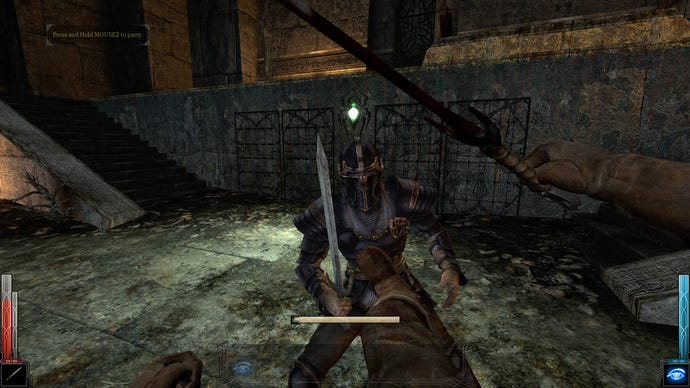 Preparing to kick an enemy into spikes in a Dark Messiah Of Might & Magic screenshot.