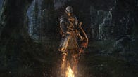 The Chosen Undead stands before a bonfire in Dark Souls Remastered artwork.