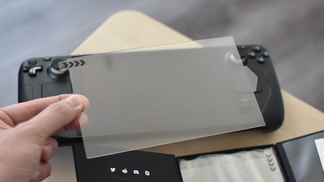 The Dbrand Tempered Glass Screen Protector being held above a Steam Deck.