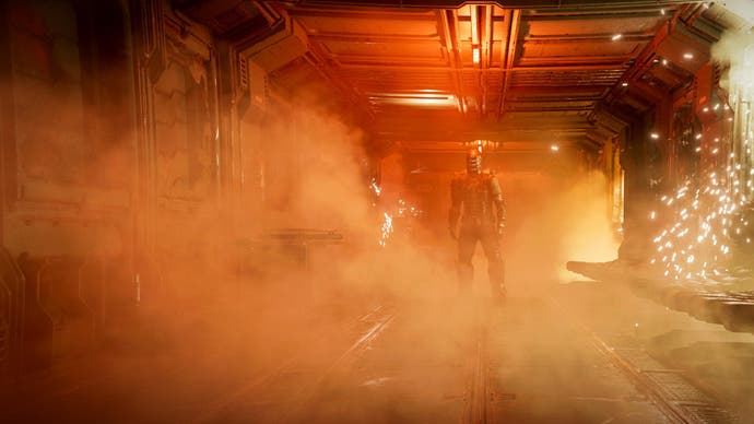 Dead Space remake review - Isaac Clarke stands offset to the right, facing the camera at the end of a corridor lit in orange-red, with sparks flying from the right