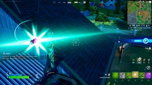 Fortnite Deku's Blast: An animated man in black armor holds a glowing green light in his right hand. He's levitating over a house and is about to release the light