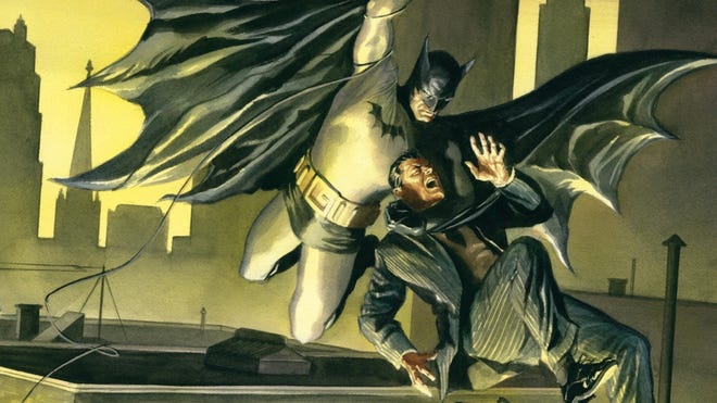 Batman holds a criminal while swinging