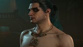 Diablo 4 Ice Shard Sorcerer build: A man with green hair in a ponytail and heavy eyeshadow is standing in a dark room. He's shirtless and wears a heavy gold pendant around his neck.