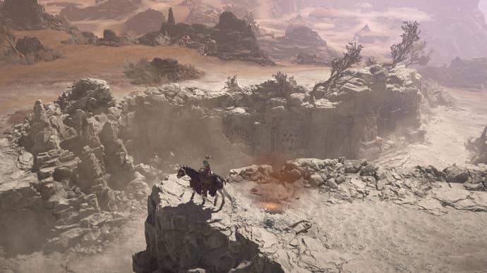 Diablo 4 character on horse overlooking chasm.