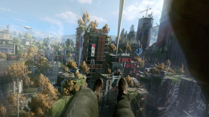 A promotional screenshot from a preview of Dying Light 2, showing the protagonist's first person view of ziplining to the roof of a skyscraper. Trees and plants have begun to grow on all the buildings in the city