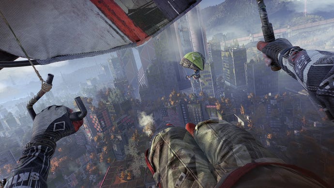 The player hang-glides through an urban cityscape dotted with trees in Dying Light 2