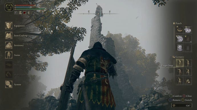 Elden Ring: the player looks up at a tower in Mistwood Ruins, upon which is perched the warrior, Blaidd the Half-Wolf.