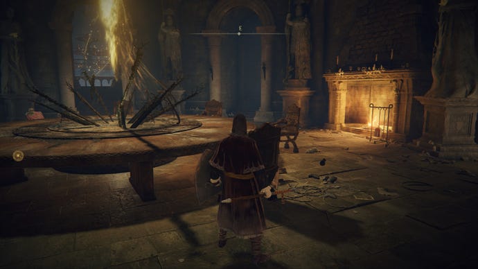 Elden Ring player standing by a large table near a roaring fire in the Roundtable Hold