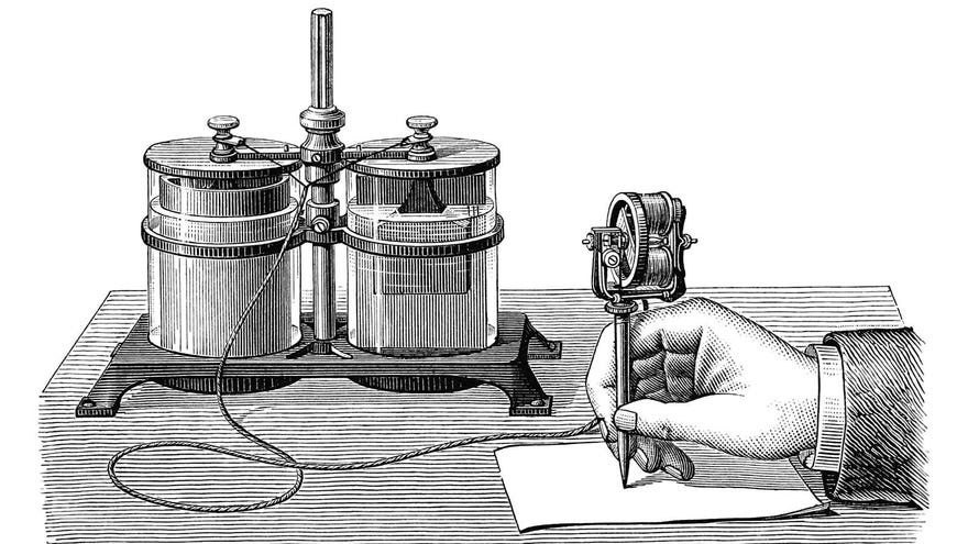 A hand is seen writing on a stencil with Edison’s electric pen connected to a wet cell battery. Edison’s electric pen was a device used for duplicating handwritten or hand-drawn documents.