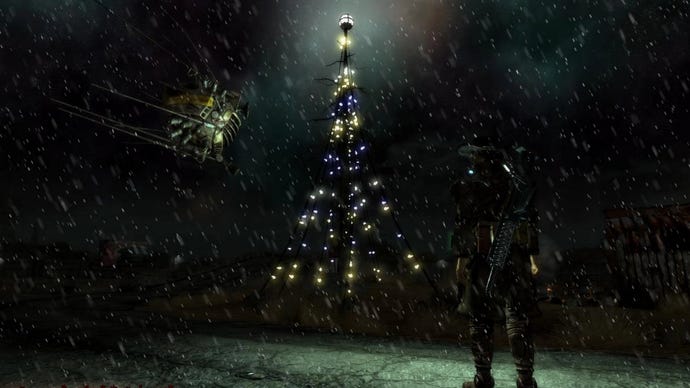 A man looks up at a tower covered in electric lights in the Electro City mod for Fallout: New Vegas