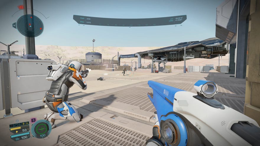 Elite Dangerous: Odyssey - One Commander in a space suit crouches, aiming a gun at a base on the surface of a dusty, beige planet. The first-person player holds a space-y looking blue and white rifle with a scope.