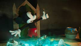 Mickey Mouse holding up a paintbrush while sat on a chair.
